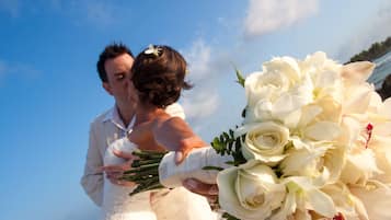 Bride exchanges vows in a serene outdoor setting.