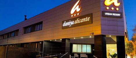 A modern building with a prominent sign reading "daniya Alicante URBAN RESORT".
