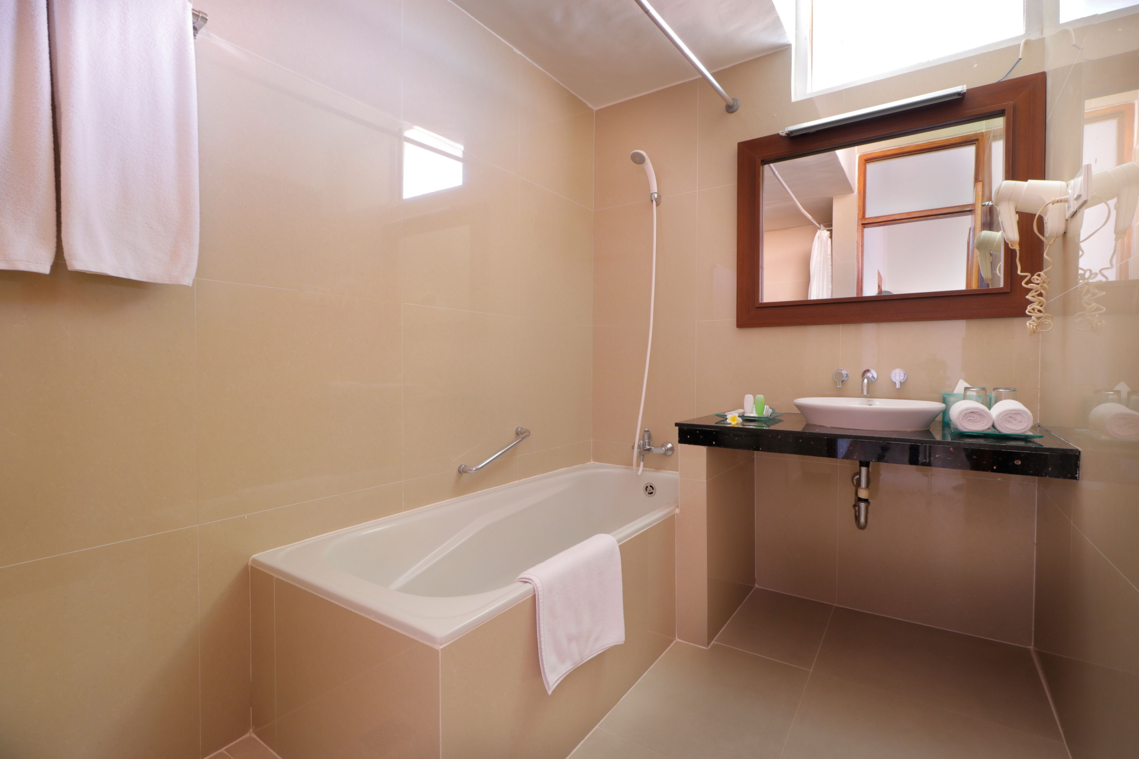 combined shower/bathtub, free toiletries, hair dryer, slippers