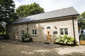 A stone building with a wooden door, two windows, and a small porch area. - Normanton Park Hotel, BW Signature Collection (Oakham)