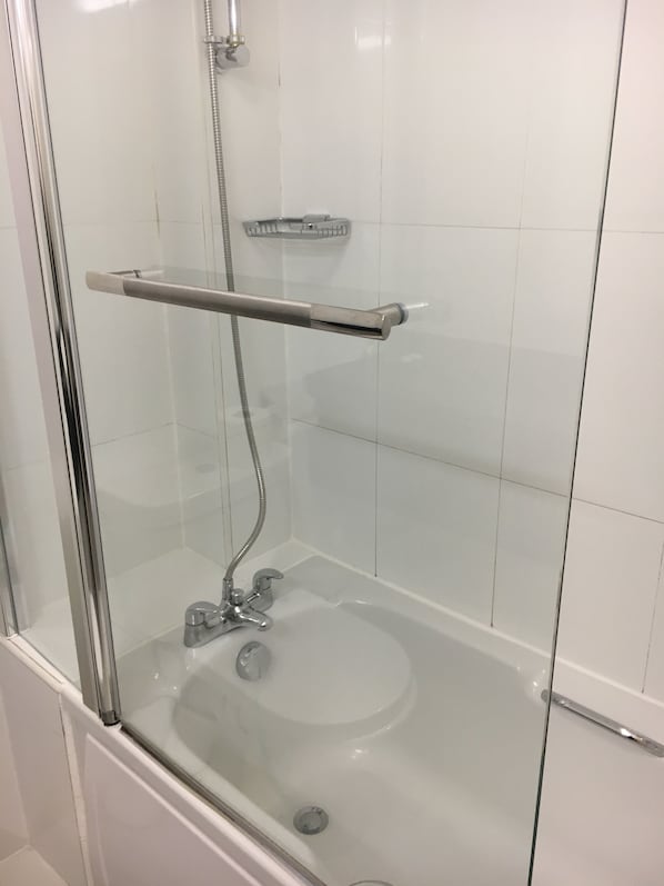 A glass-enclosed shower with a chrome faucet and a handheld showerhead. - Normanton Park Hotel, BW Signature Collection (Oakham)