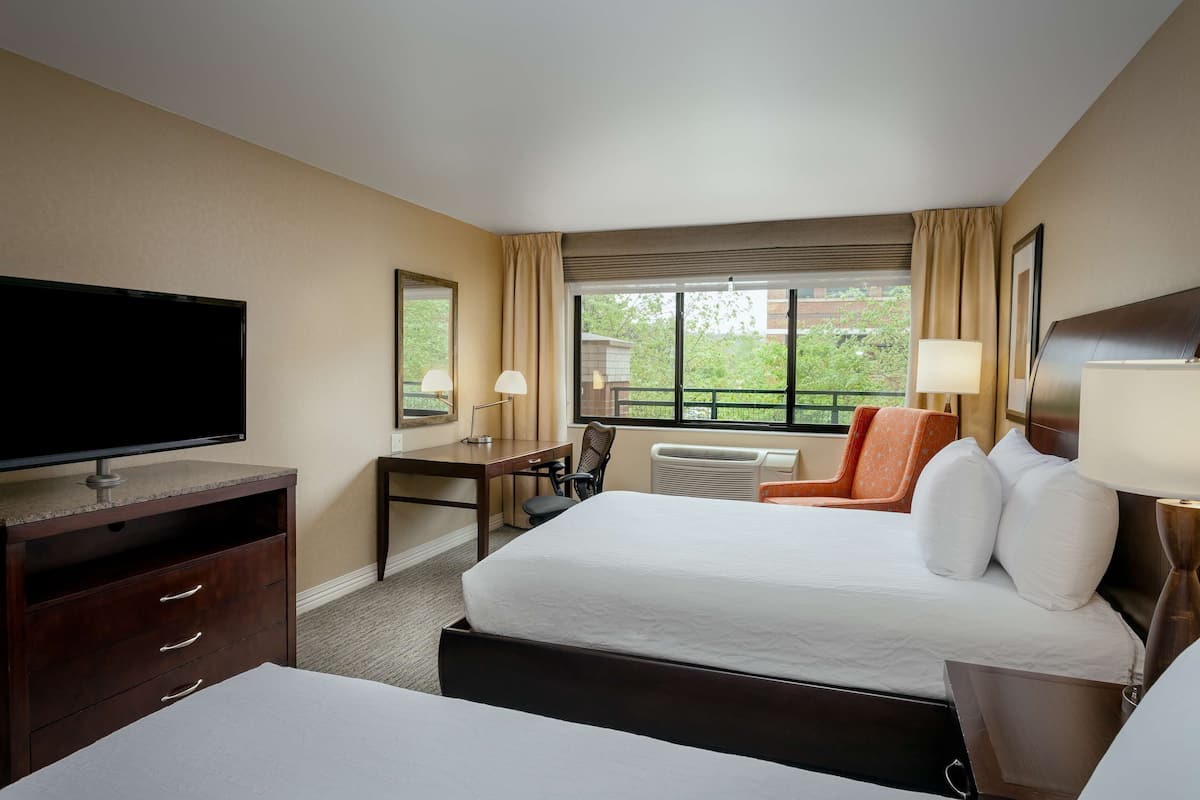 Hypo-allergenic bedding, desk, laptop workspace, blackout drapes