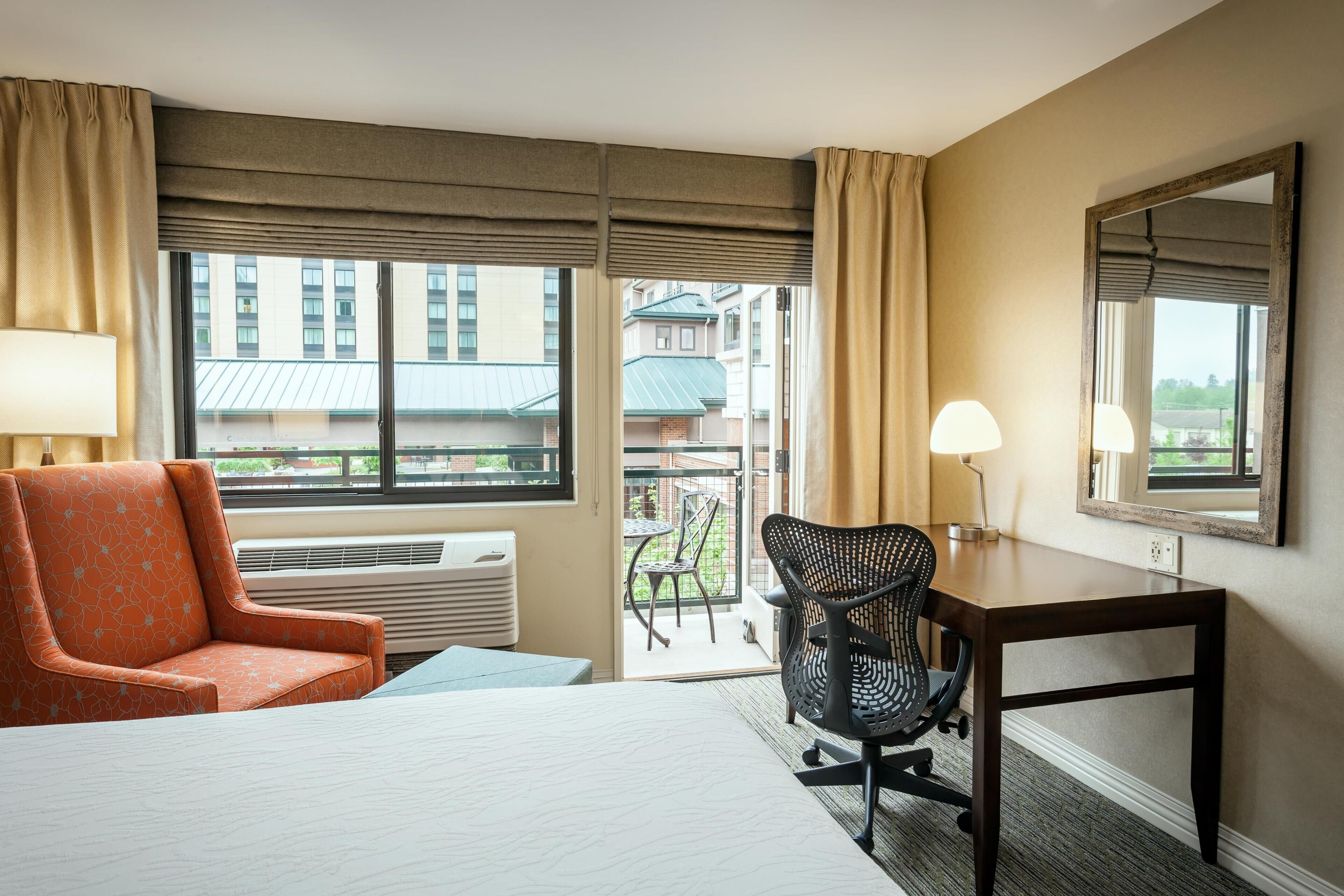 Hypo-allergenic bedding, desk, laptop workspace, blackout drapes