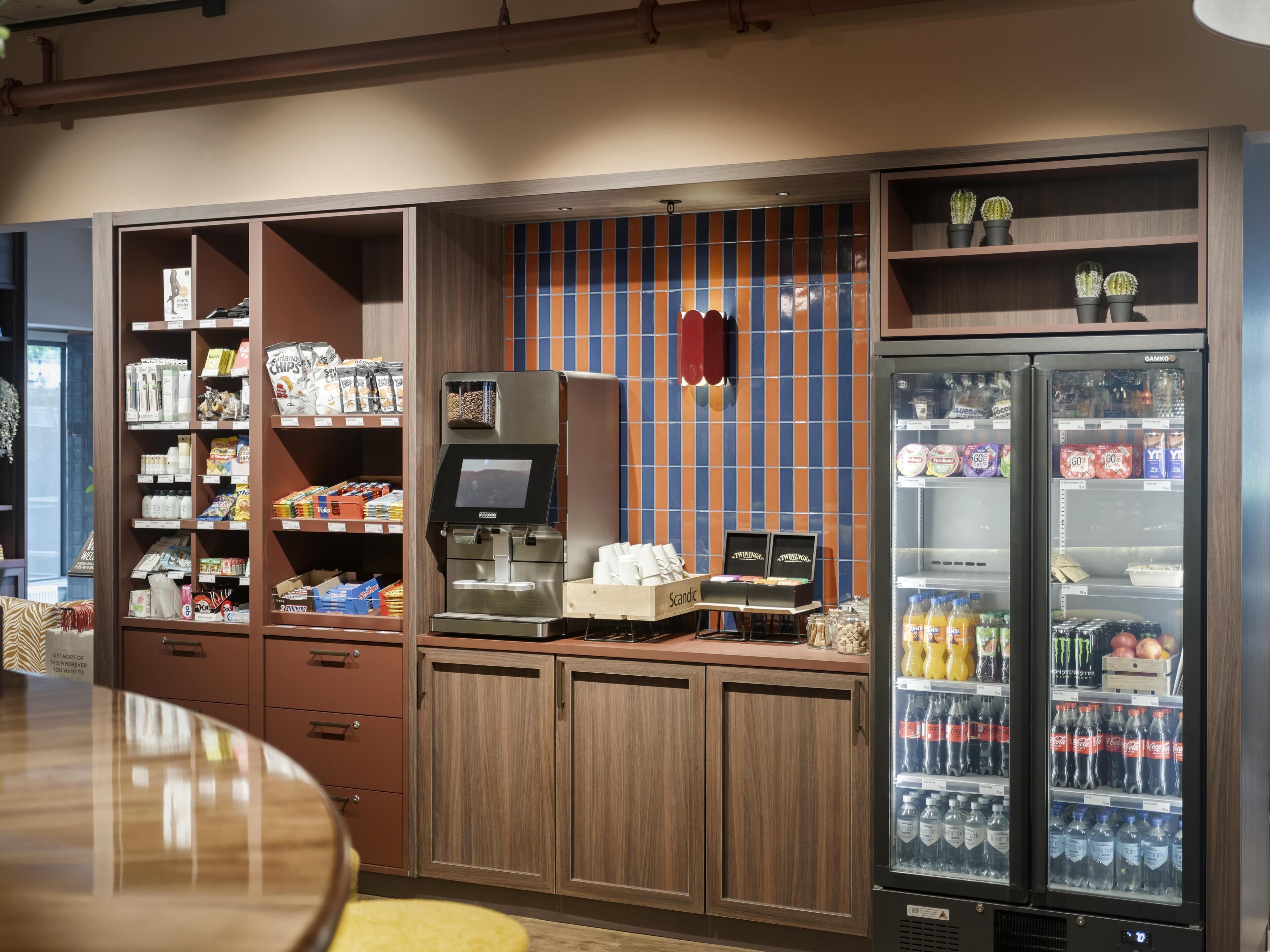 A self-service beverage station with a coffee machine, a refrigerated drink dispenser, and a snack vending machine.