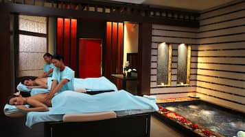 Experience rejuvenation in this serene spa treatment room, featuring massage tables and a tranquil pool area.