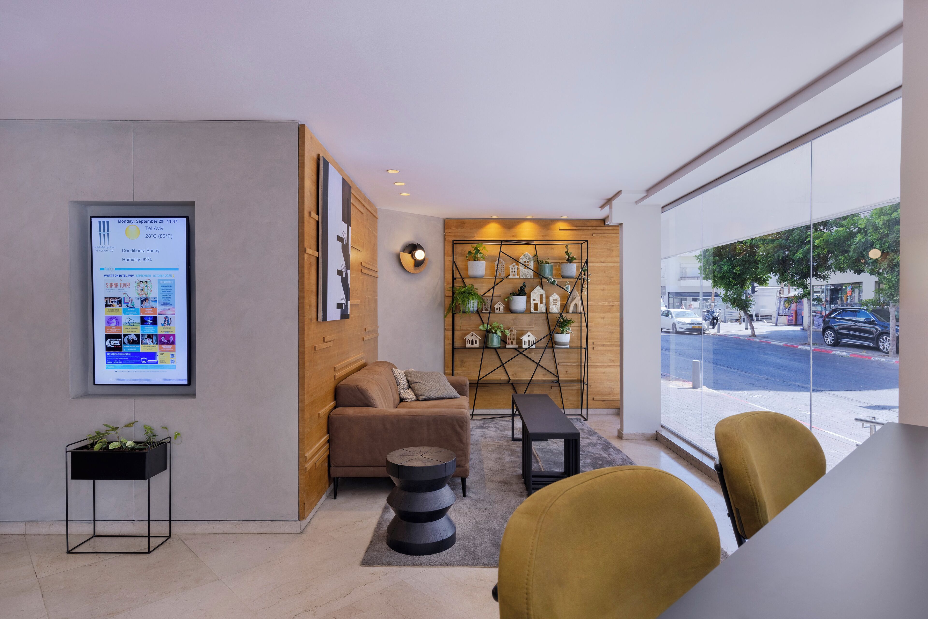 A modern interior with a sofa, a coffee table, a small side table, and a seating area with chairs.