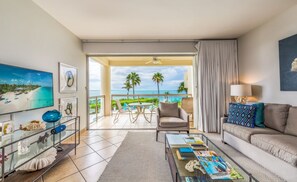1-Bedroom Oceanfront (4201) | Living room | 50-inch flat-screen TV with cable channels, TV - Coral Gardens on Grace Bay (Providenciales)