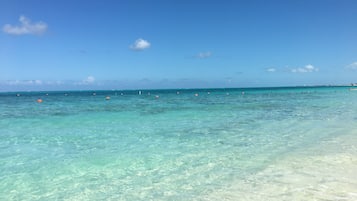 On the beach, white sand, sun-loungers, beach umbrellas