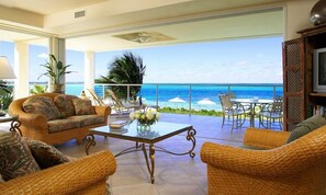 2-Bedroom Oceanfront (1202) | Living area | 50-inch flat-screen TV with cable channels, TV - Coral Gardens on Grace Bay (Providenciales)