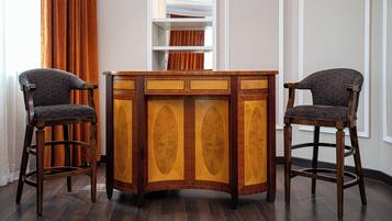 A bar area with two high stools and a central bar counter.