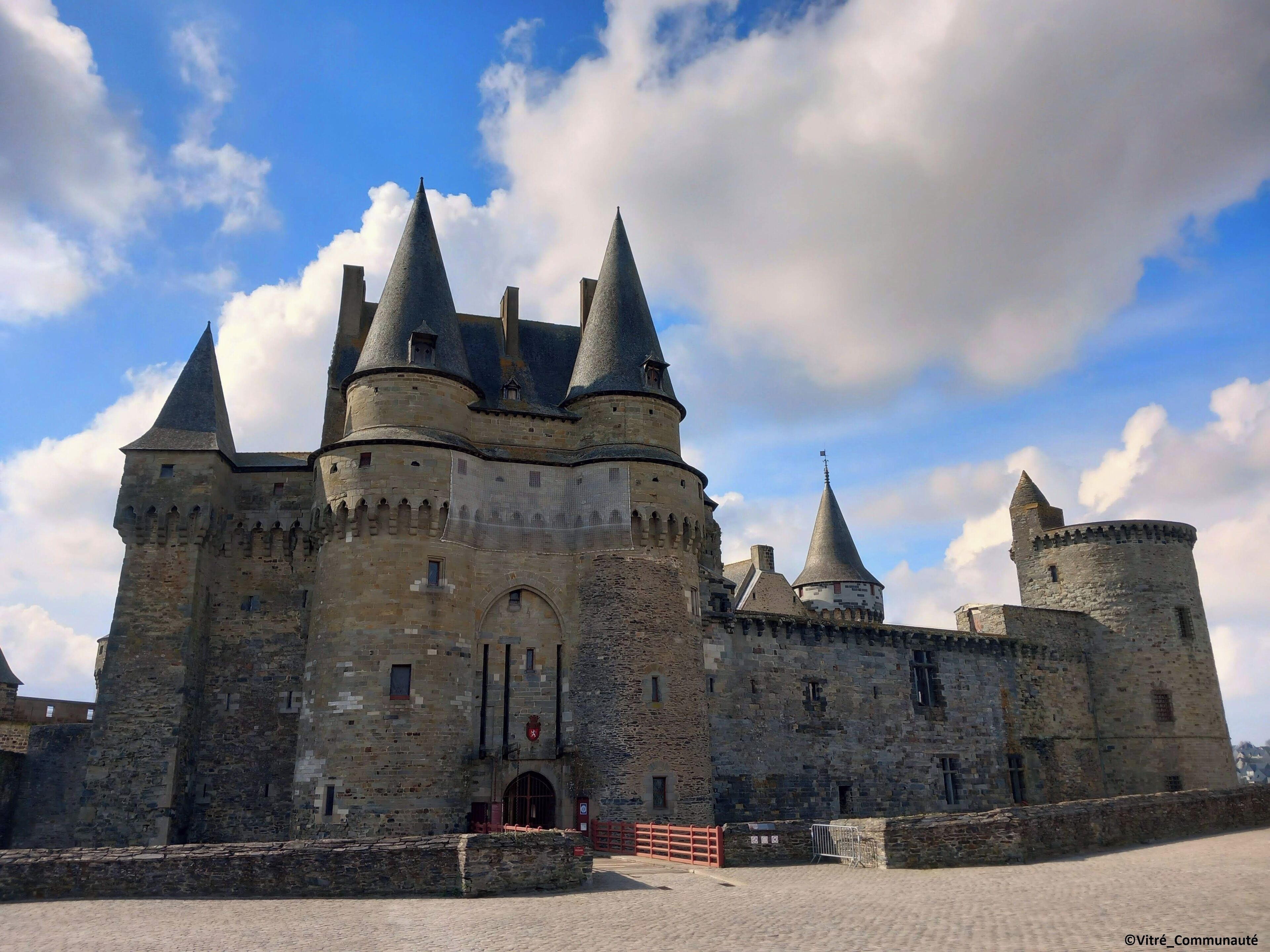 A historic castle with multiple towers and a central entrance.
