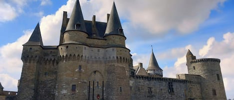 A historic castle with multiple towers and a central entrance.