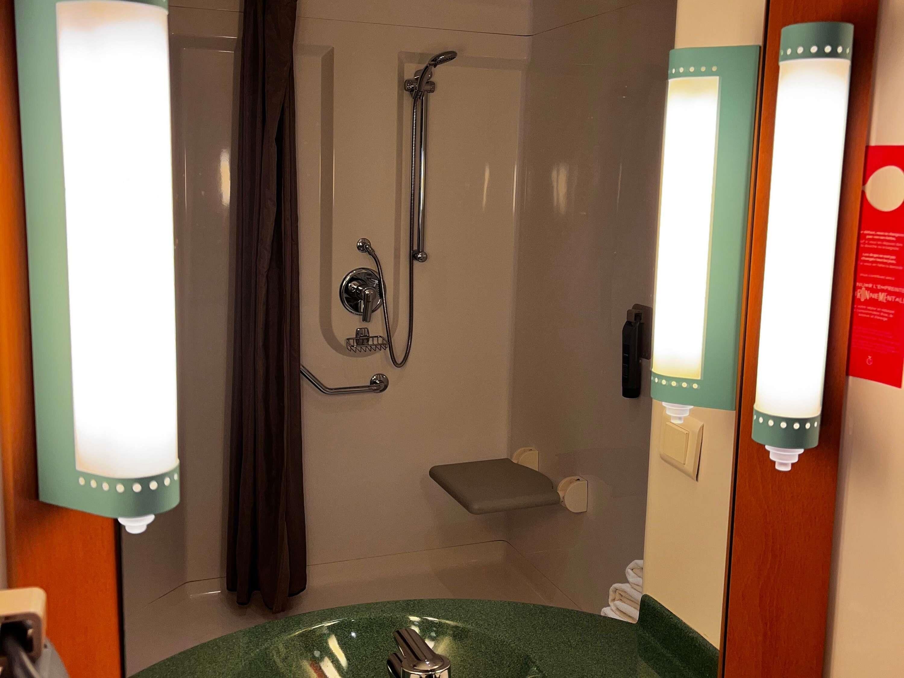 A bathroom with a shower, a sink, and a toilet.