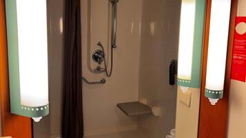 A bathroom with a shower, a sink, and a toilet.