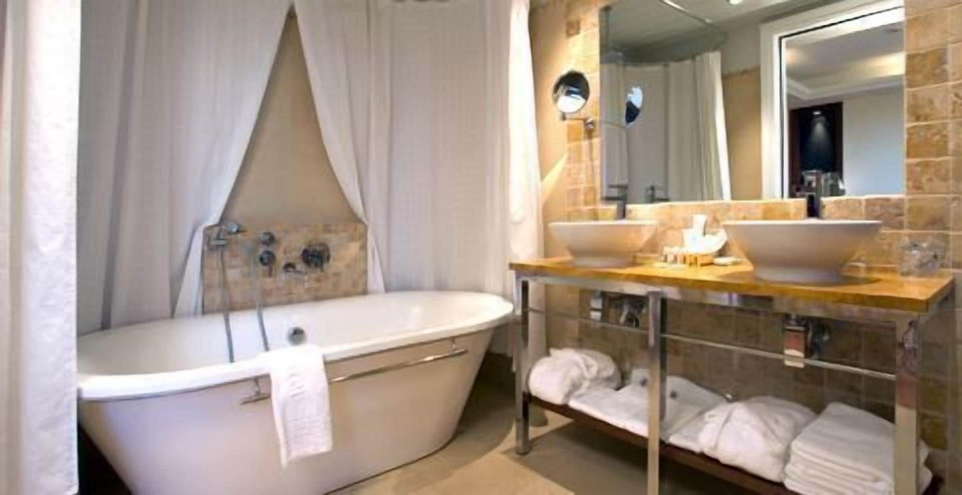 bathtub, hair dryer, slippers, towels