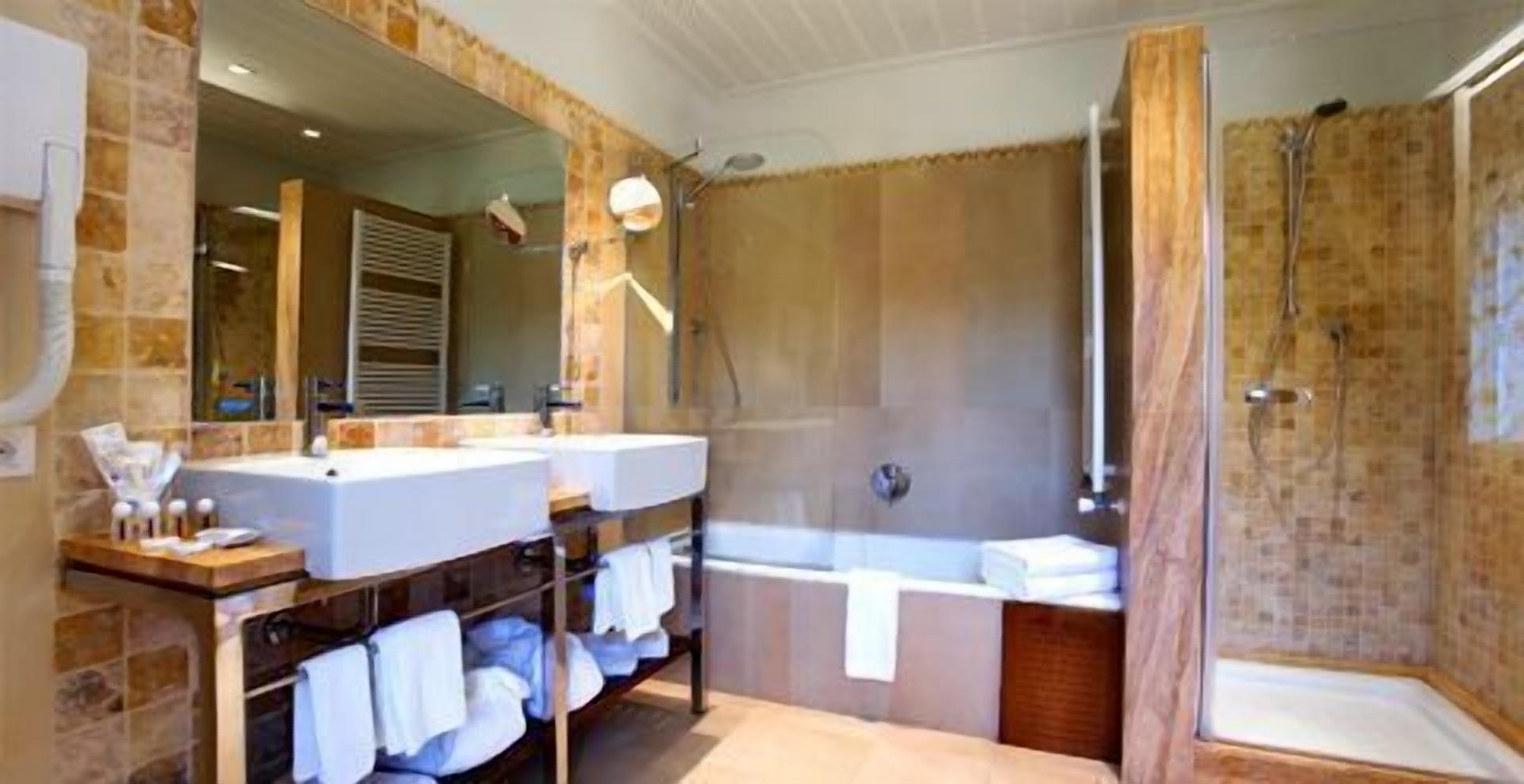 bathtub, hair dryer, slippers, towels