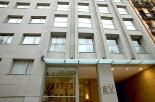 A modern hotel building with a prominent entrance, large windows, and a sign reading "SV BUTLER VIENNA".