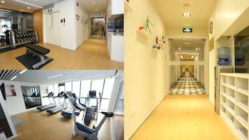 A gym with treadmills, elliptical machines, and weight benches.