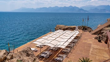 Private beach, black sand, sun loungers, beach umbrellas