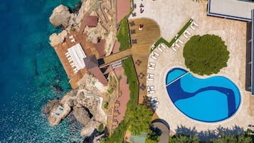 Indoor pool, seasonal outdoor pool, pool umbrellas, pool loungers