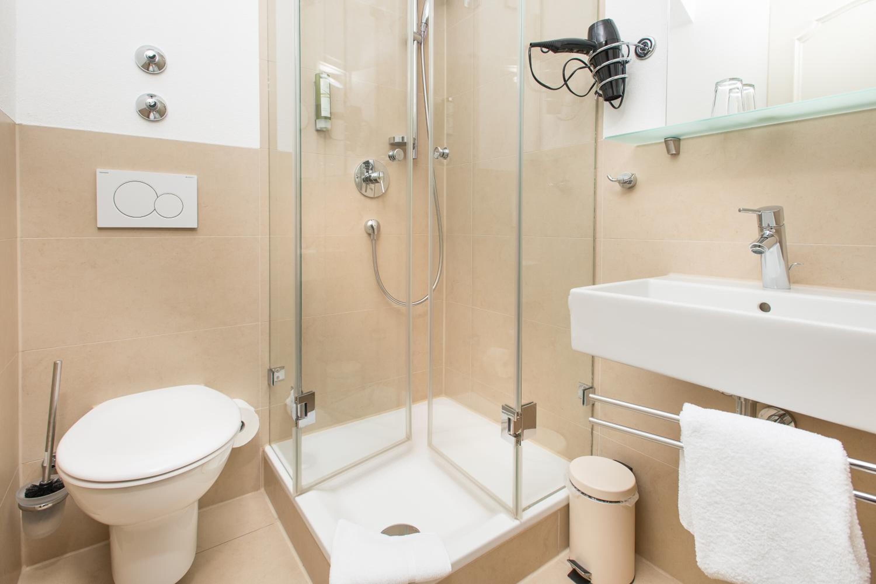 shower, hair dryer, slippers, towels