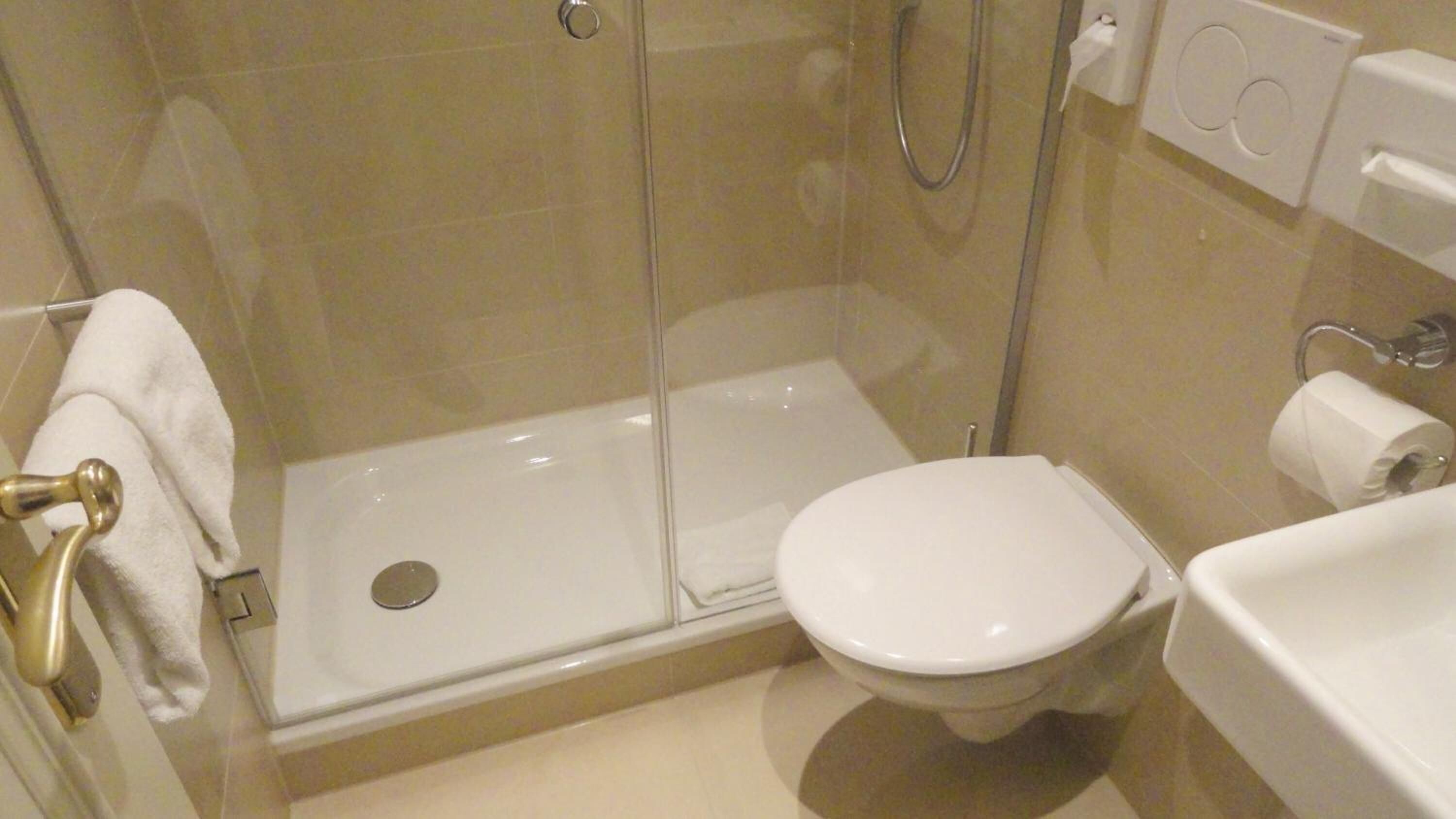 shower, hair dryer, slippers, towels