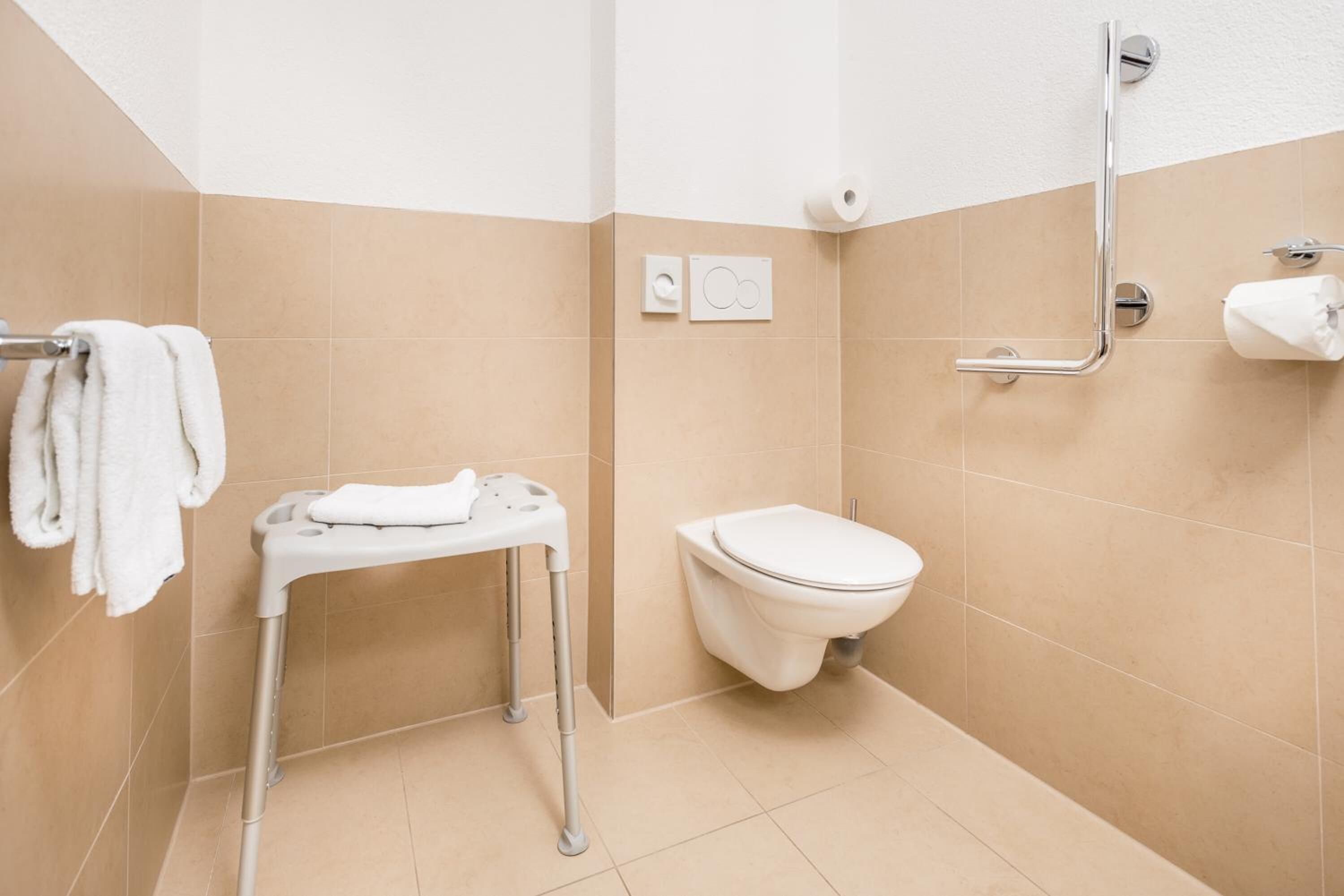 shower, hair dryer, slippers, towels