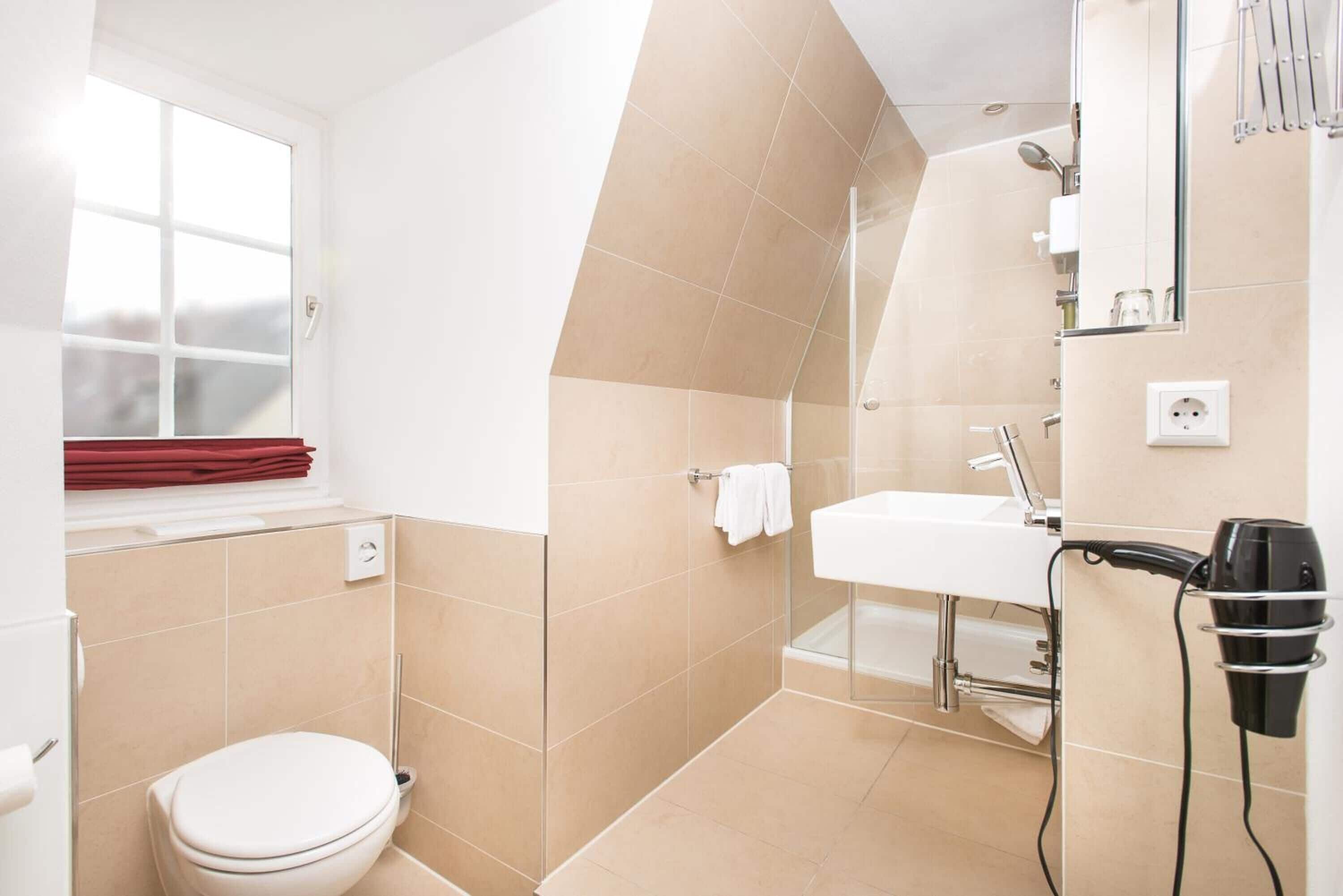 shower, hair dryer, slippers, towels