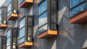 A modern building facade with multiple windows and balconies. - Résidence Hôtelière Odalys l'Archipel (La Rochelle)