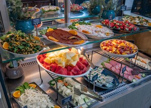 A buffet with various food options including fruits, salads, and meats. - Niles Hotel Istanbul - Special Class (Istanbul)