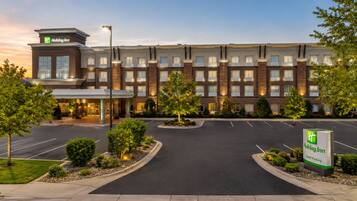 A Holiday Inn hotel with a brick facade, a covered entrance, and a parking lot.