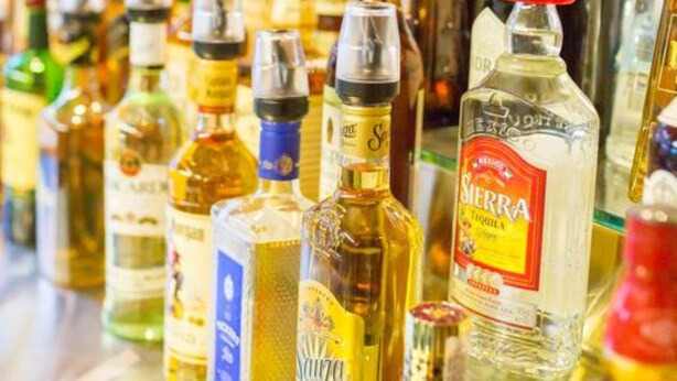 A variety of liquor bottles on a bar counter. - Highlander Hotel (Gilles Plains)