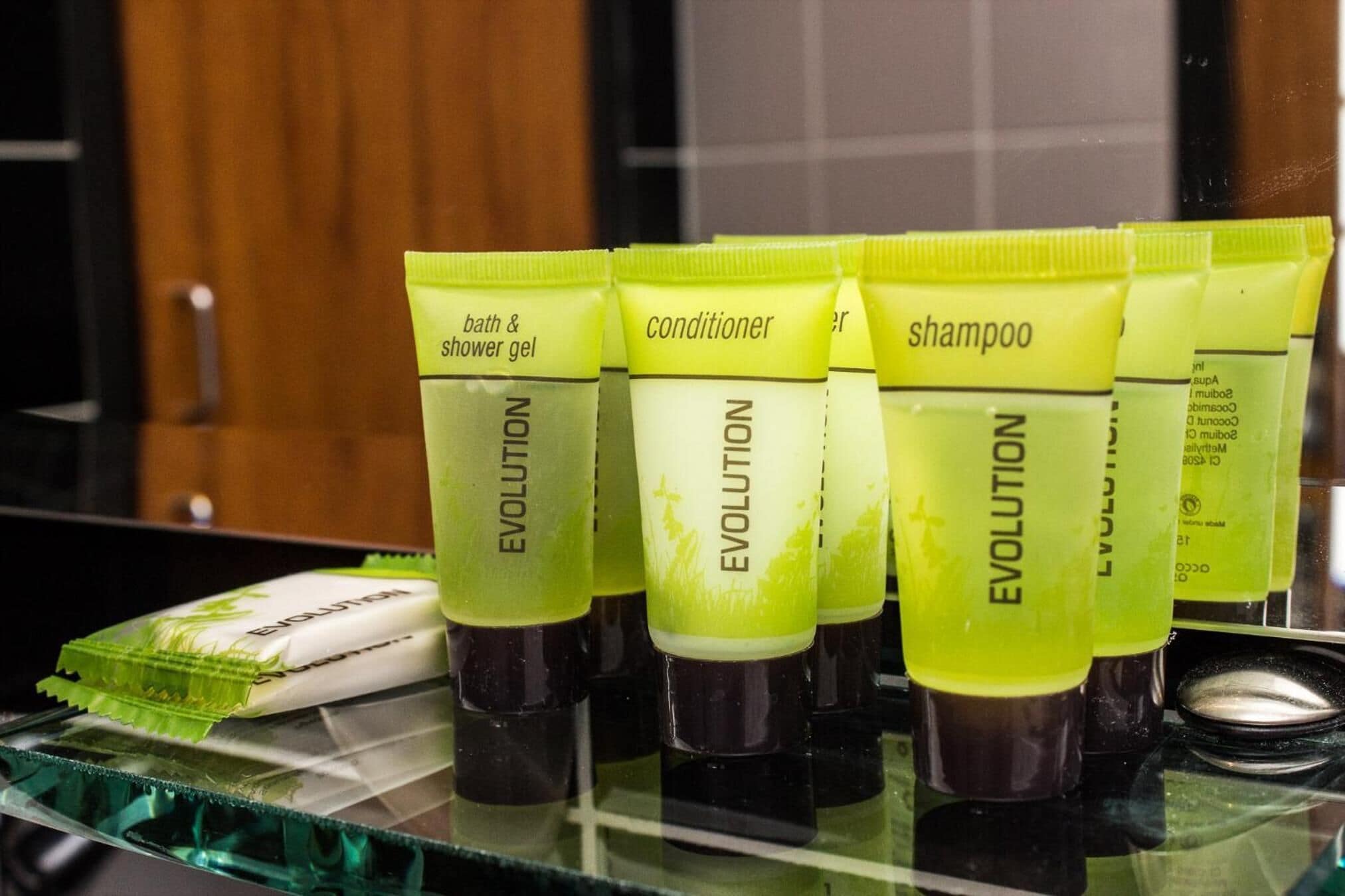A display of toiletries including shower gel, conditioner, and shampoo.