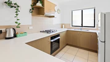 Full-sized fridge, microwave, stovetop, coffee/tea maker