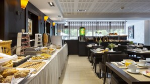 A breakfast buffet with various food items and a coffee station. - Residence La Reserve (Ferney-Voltaire)