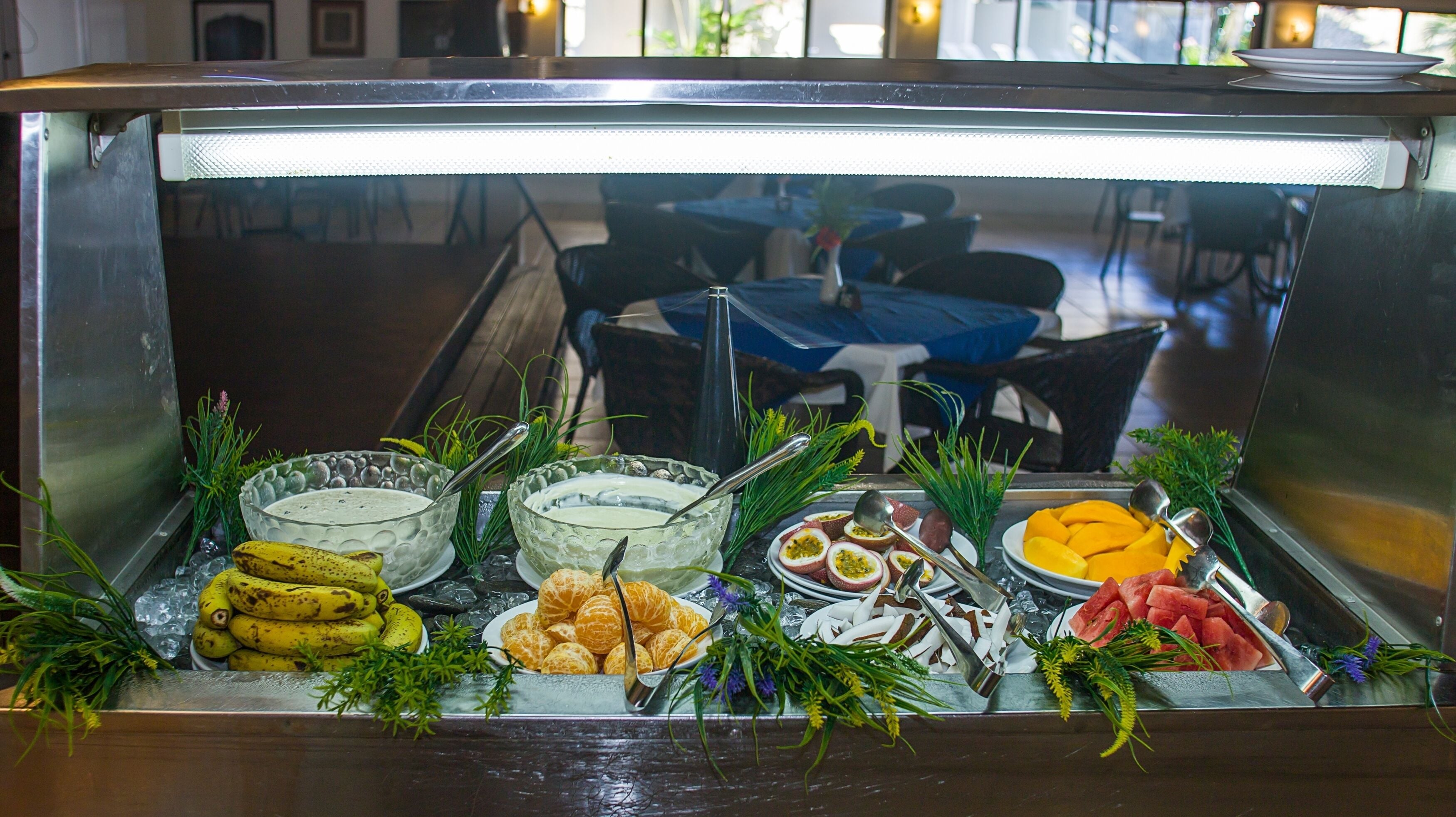 A buffet with various food items and garnishes.