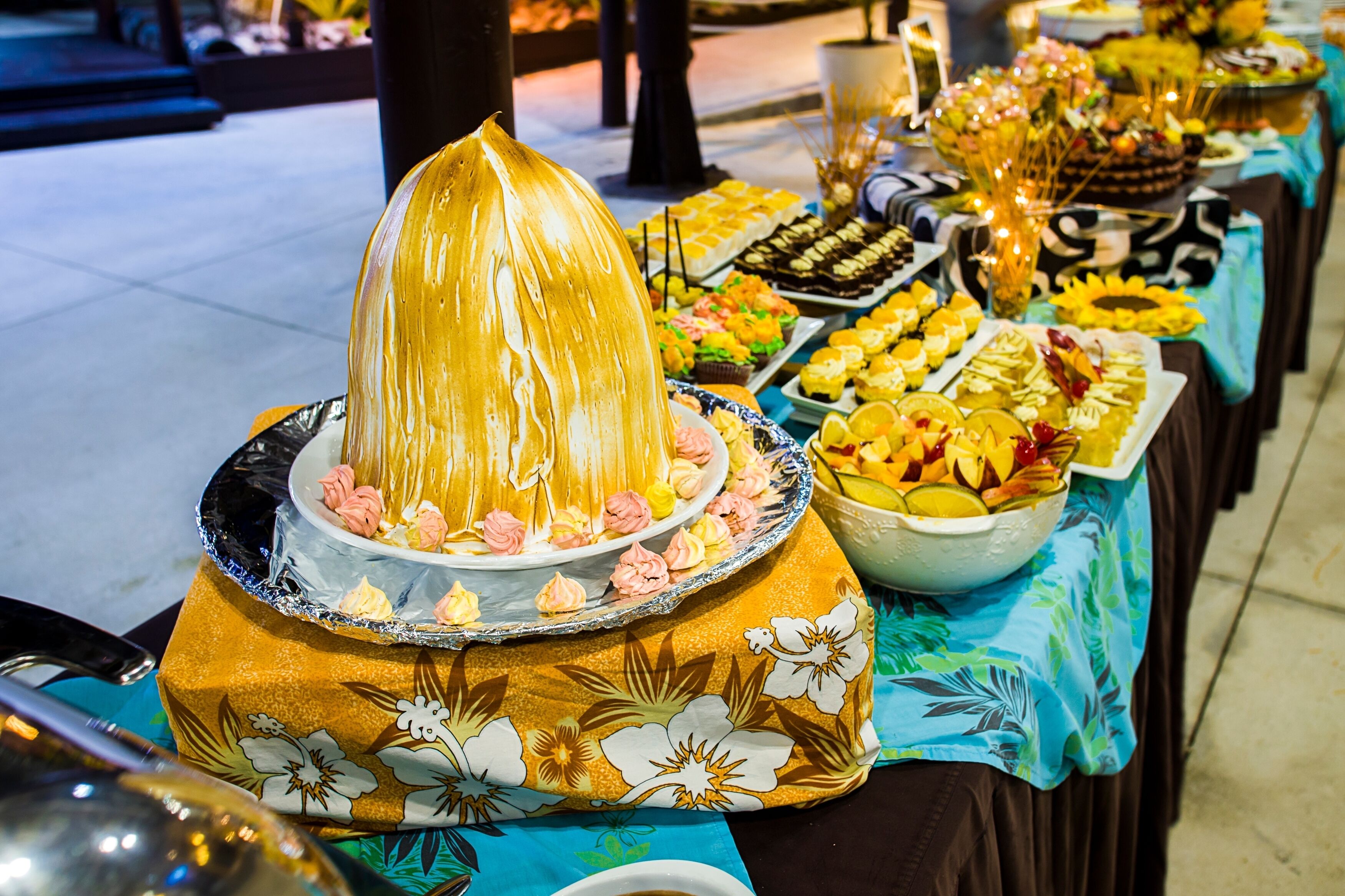 A buffet table with various food items and a centerpiece.