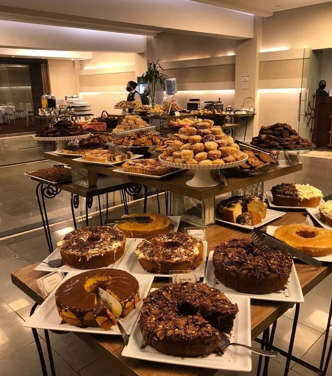A buffet with various desserts including cakes and pastries.