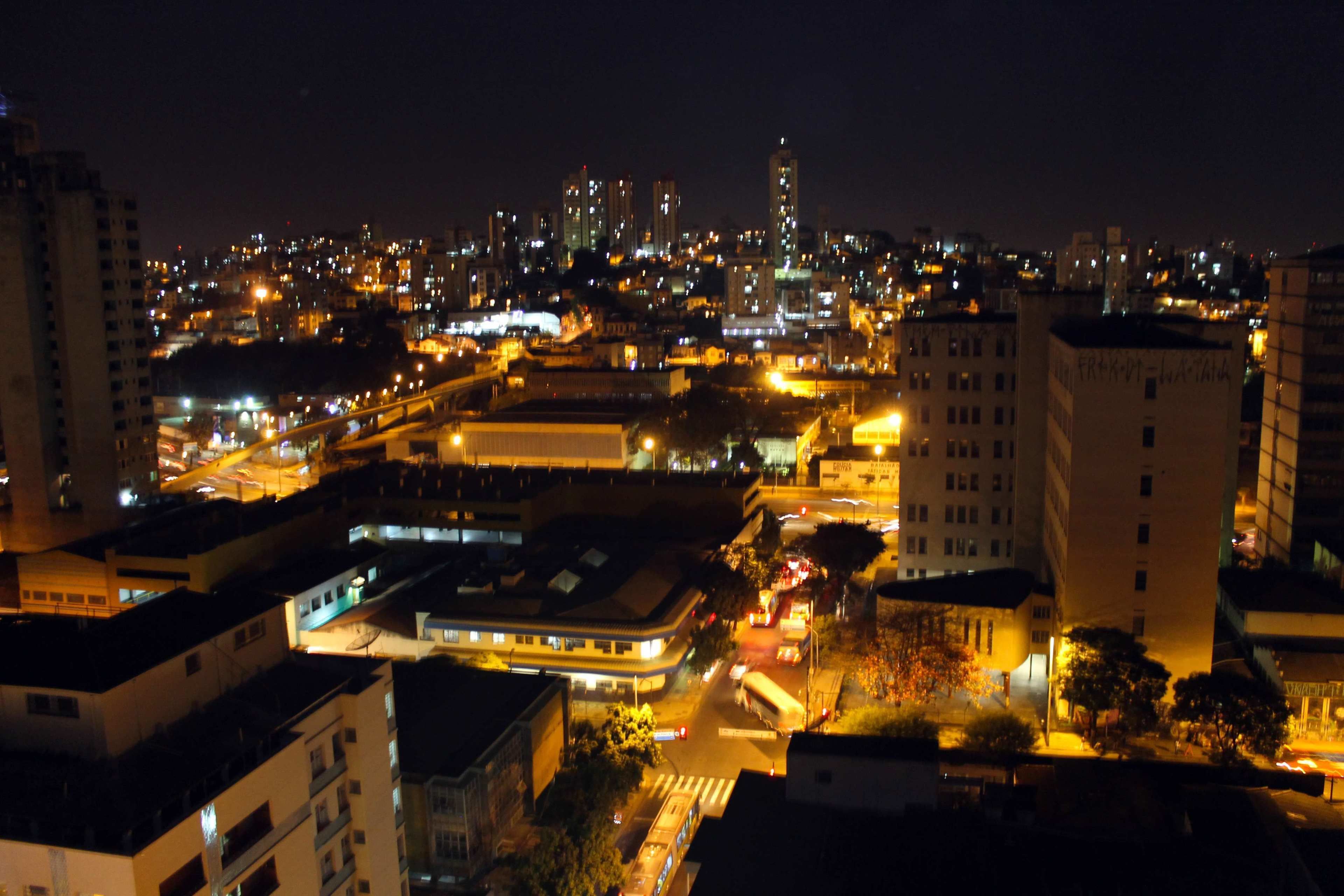 A nighttime cityscape with illuminated buildings and streets.