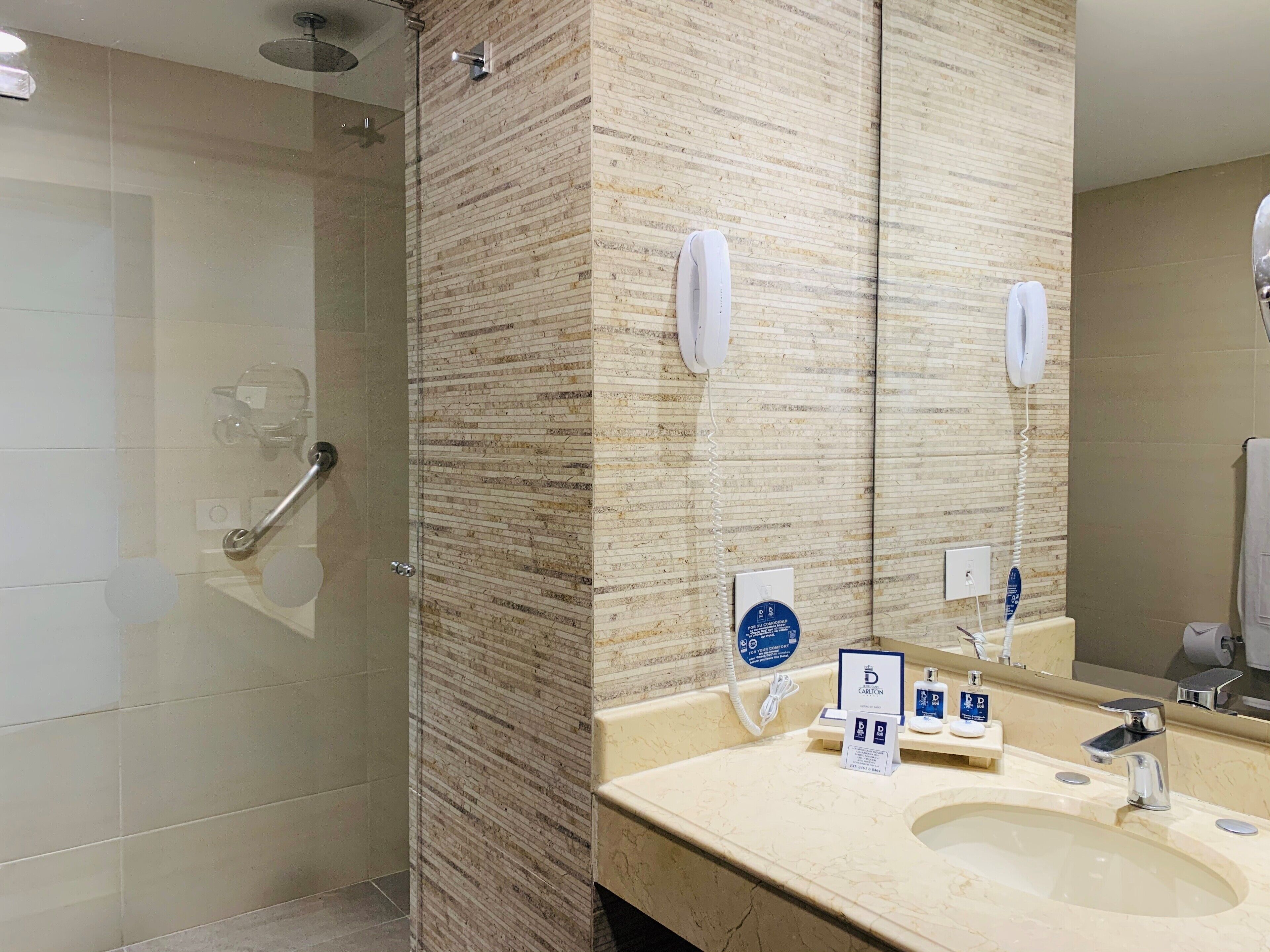 shower, hair dryer, slippers, towels