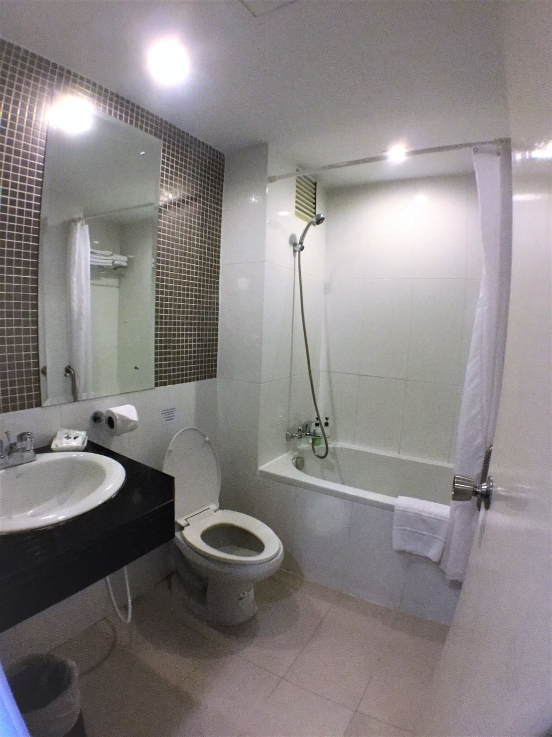 A bathroom with a sink, toilet, and bathtub.