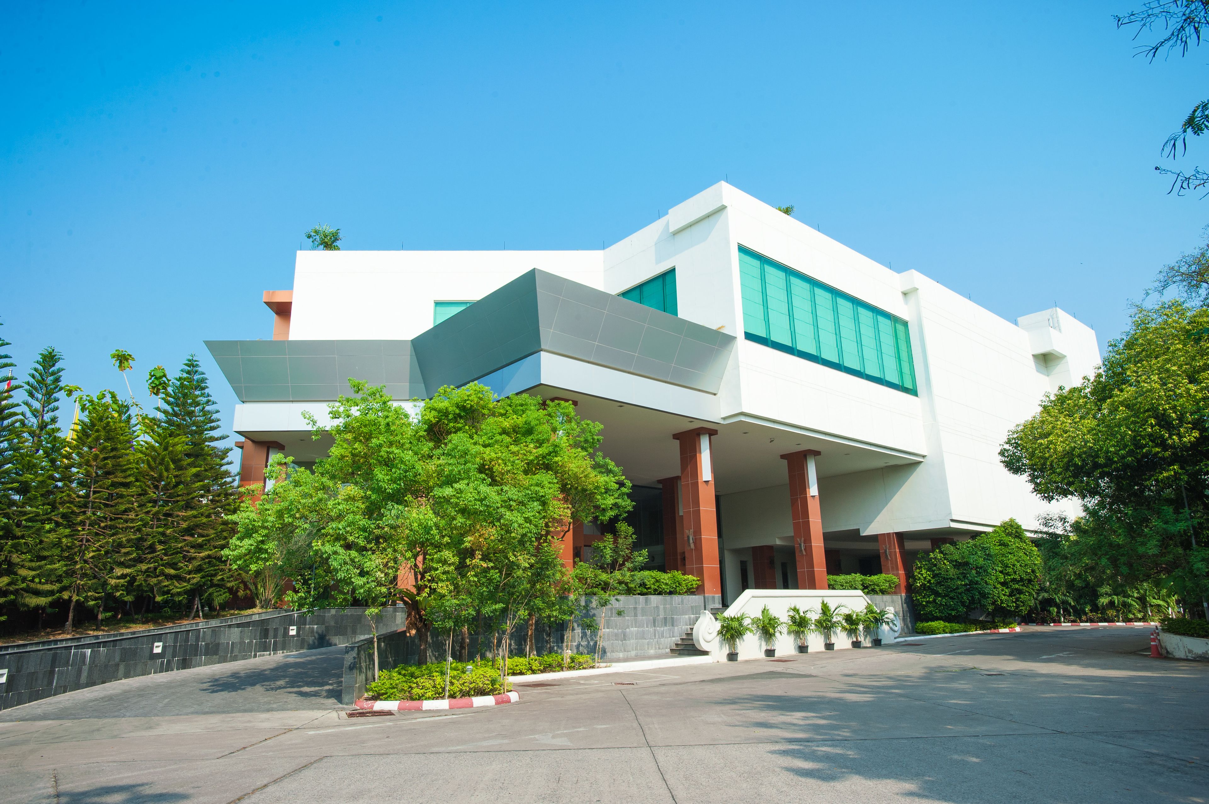 A modern building with a flat roof, large windows, and a prominent entrance.