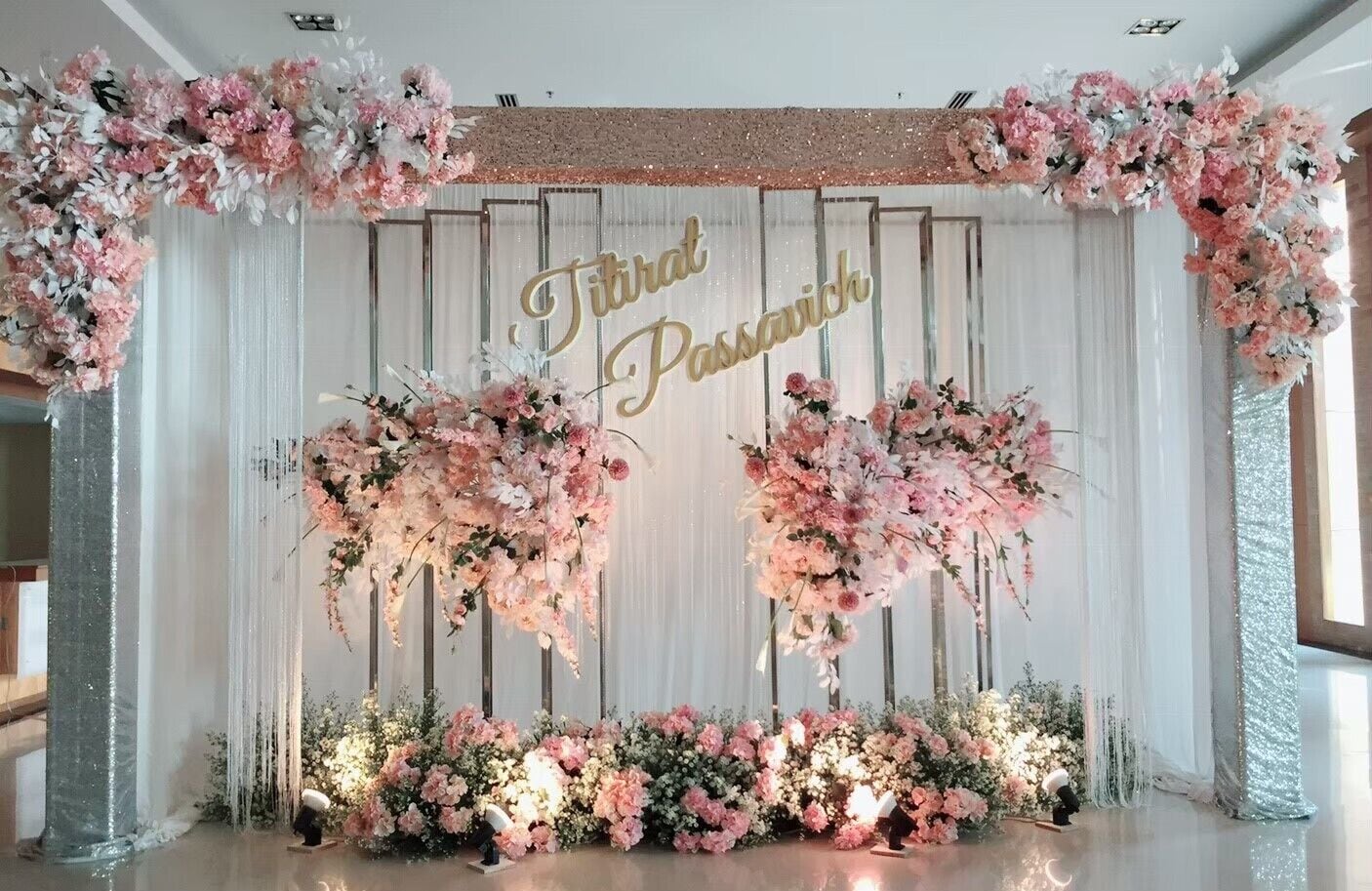 A stage with floral decorations and a sign that reads "Third Passivhaus".
