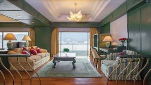 A spacious living room with a sofa, armchairs, a coffee table, and a view through large windows. - Chiangmai Grandview Hotel & Convention Center (Chiang Mai)