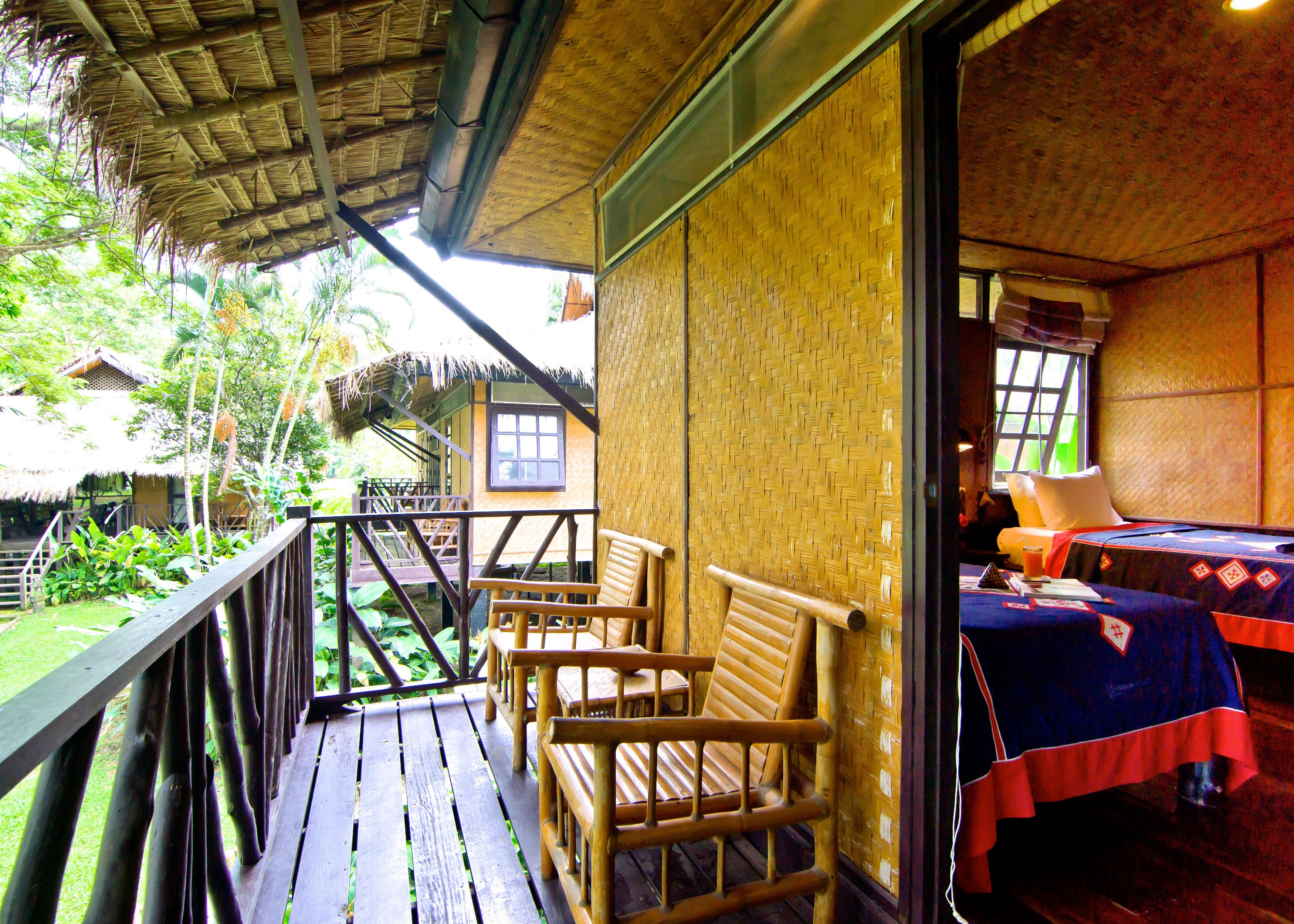 A room with a bed, a window, and a view of the outdoors.