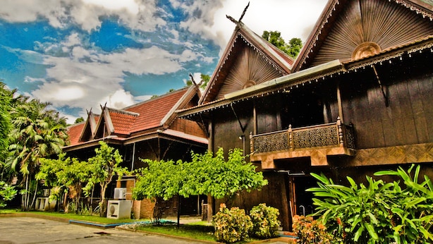 A traditional wooden building with multiple roofs and a balcony. - Baan Thai Resort (Chiang Mai)