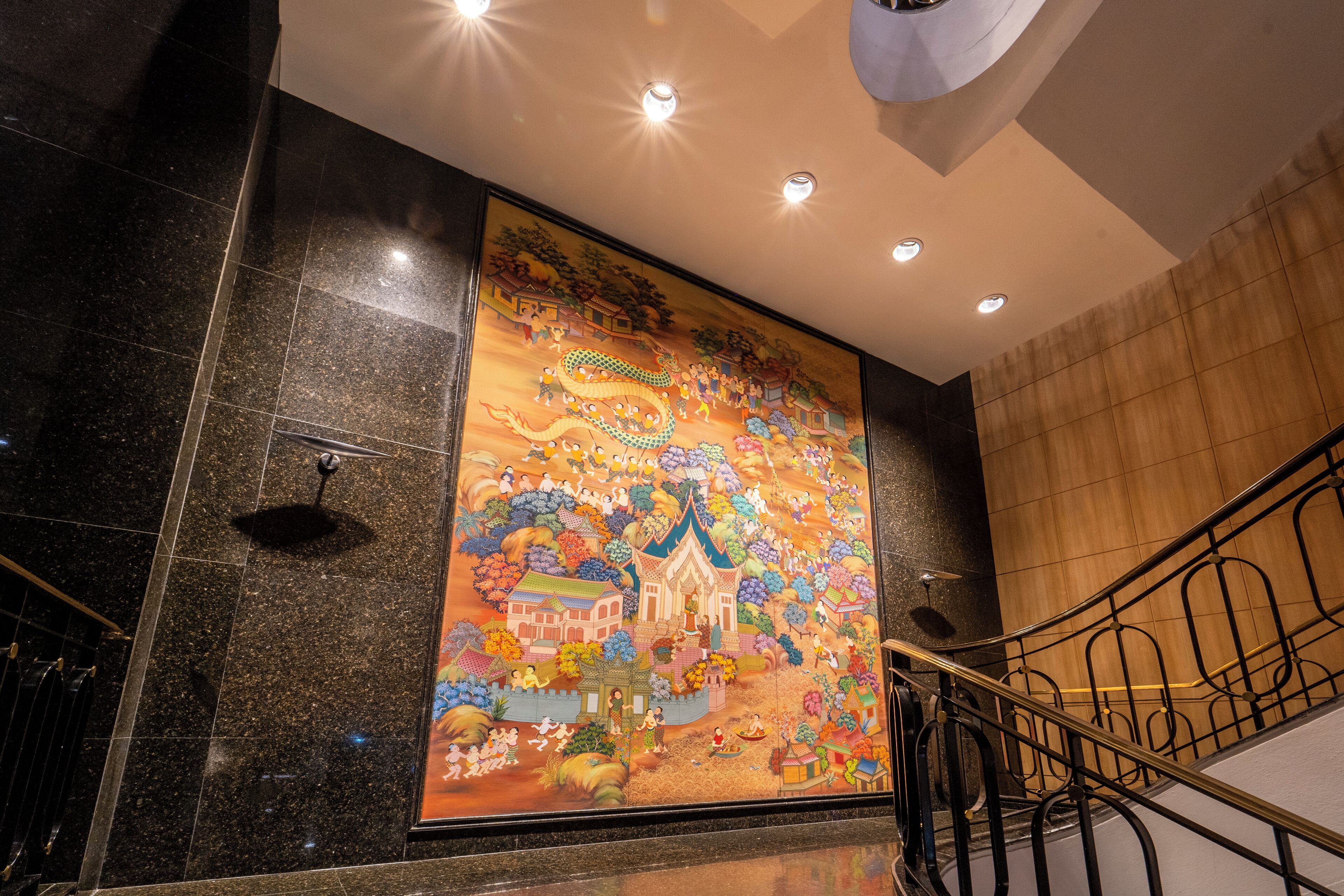 A large mural with a dragon and traditional buildings.
