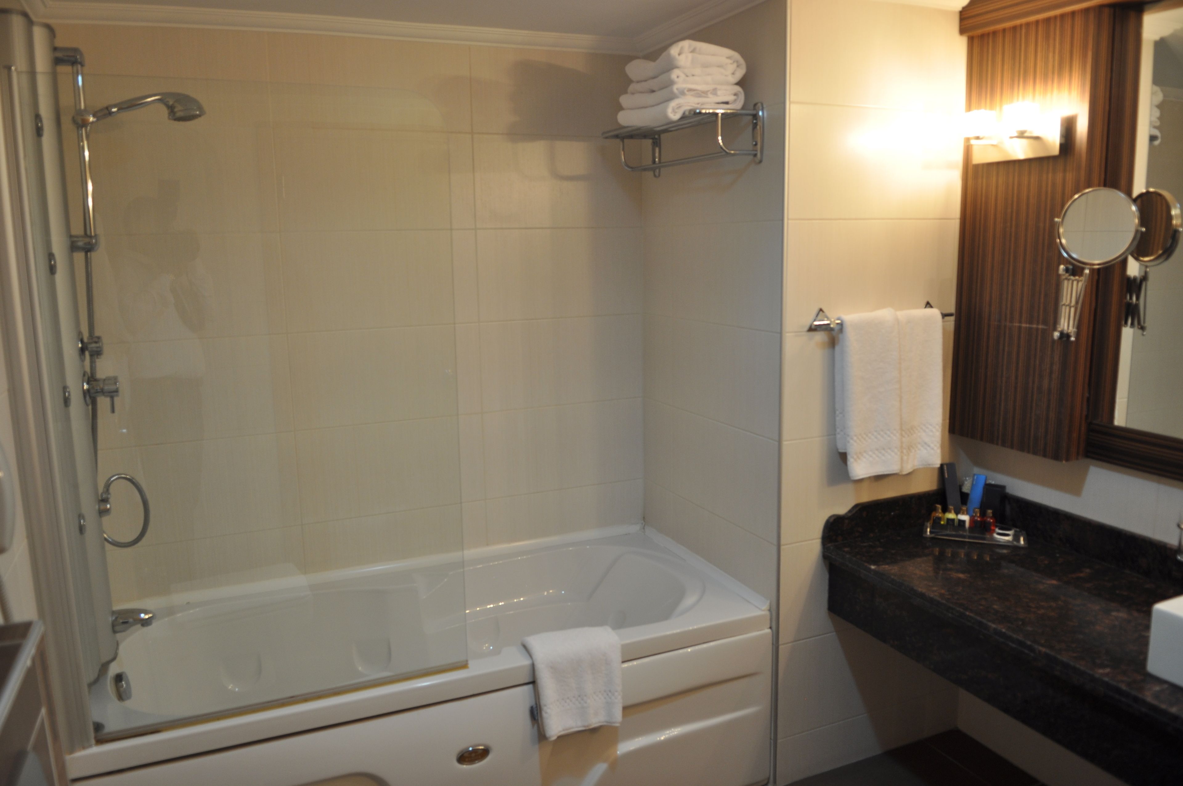 suite, 1 king bed | bathroom | combined shower/bathtub, hair dryer, slippers, towels