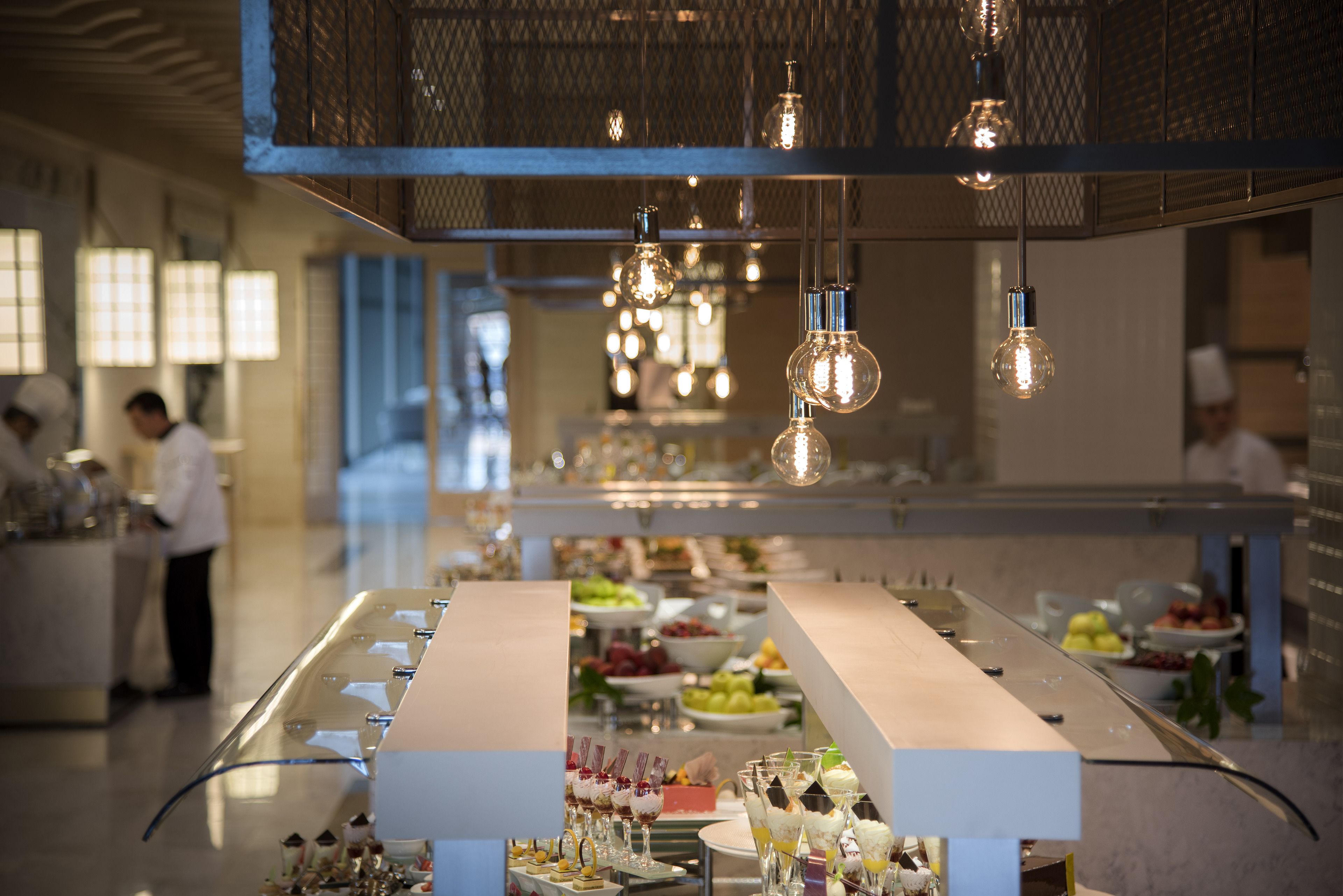 A buffet setup with various food items and a long counter.
