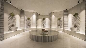 Welcome to our reception area, featuring a central round table and comfortable seating, surrounded by lush greenery and a unique, curved ceiling.